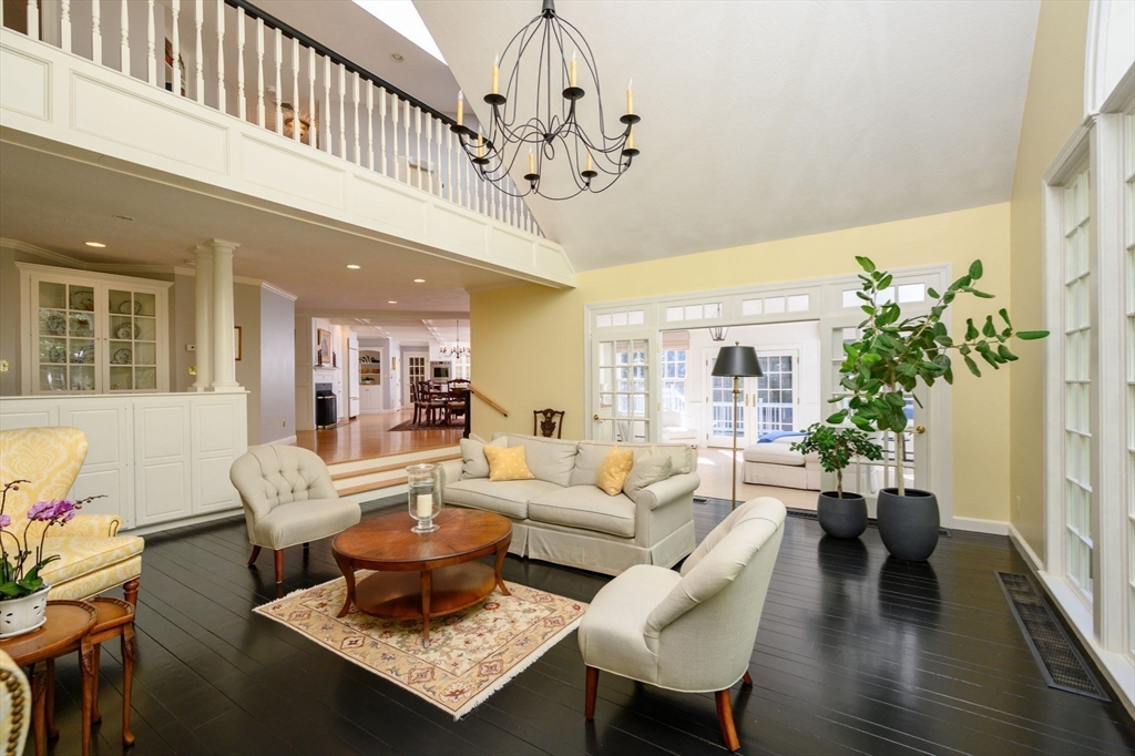 451 Main Street Norwell, MA 02061 - Photo 12 of 31 a living room with furniture a chandelier and a wooden floor
