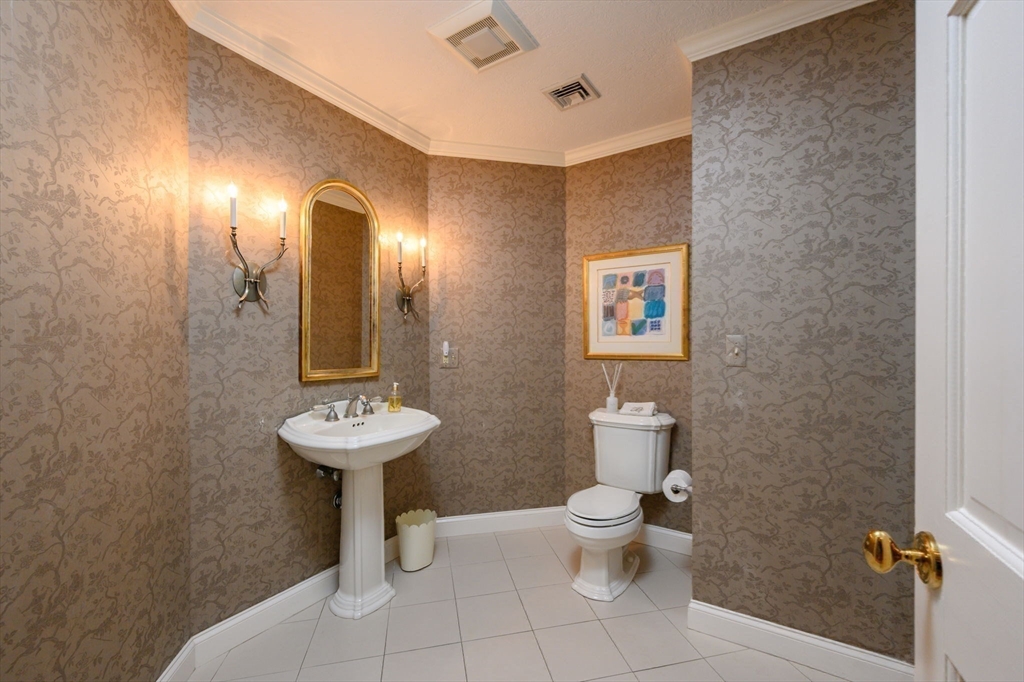451 Main Street Norwell, MA 02061 - Photo 15 of 31 a bathroom with a toilet sink and mirror