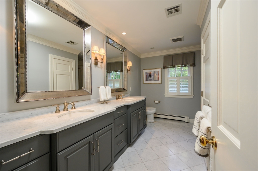 451 Main Street Norwell, MA 02061 - Photo 24 of 31 a spacious bathroom with a granite countertop sink mirror and next to a window