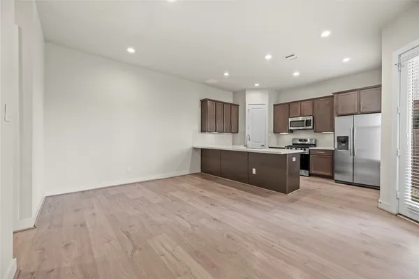a large kitchen with cabinets and stainless steel appliances