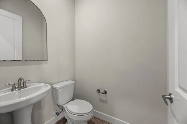 a white toilet sitting next to a bathroom sink