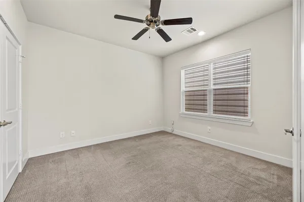 a view of a livingroom with a ceiling fan and window