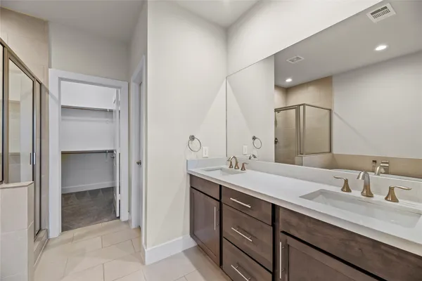 a bathroom with a sink double vanity and a mirror