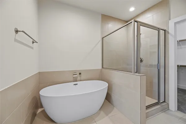 a bathroom with a bathtub and a shower