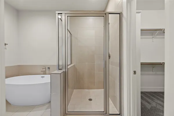 a bathroom with a shower a mirror and a sink