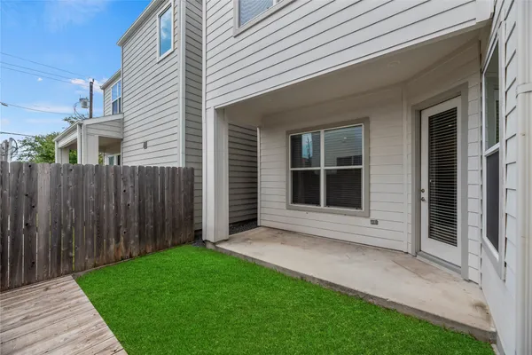 a view of backyard with wooden fence