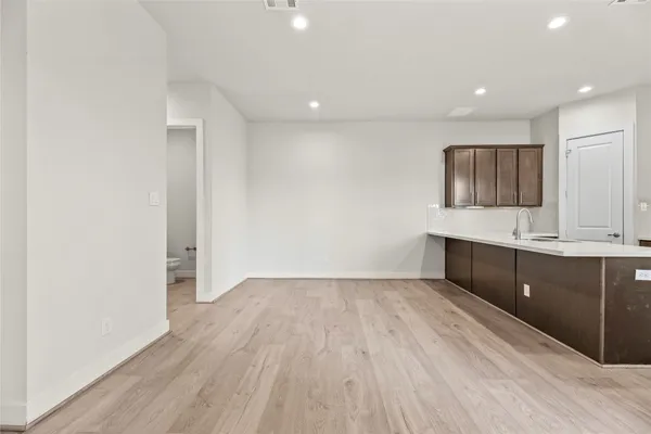 a view of kitchen with a sink and wooden floor