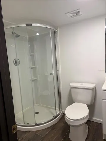 a bathroom with a toilet and a shower