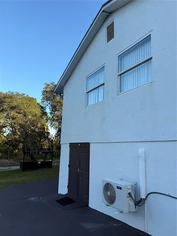 a view of swimming pool with lawn chairs and iron fence