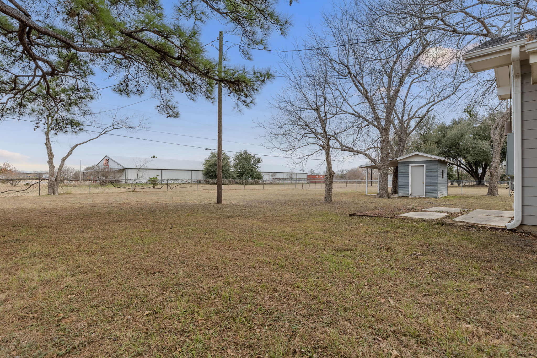 813 Central Avenue Elgin, TX 78621 - Photo 6 of 22 Fenced backyard featuring a storage shed