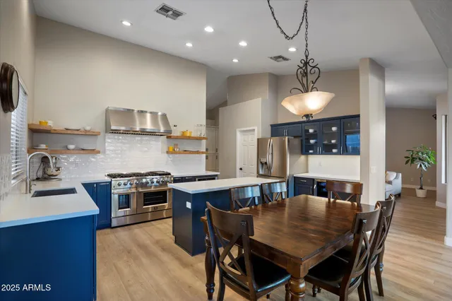 a living room with furniture and chandelier