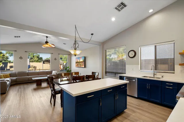 a large kitchen with a table and chairs