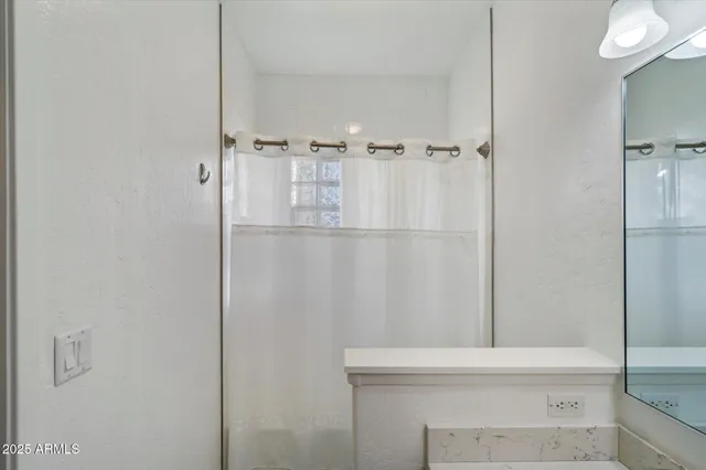 a bathroom with a sink vanity and a mirror