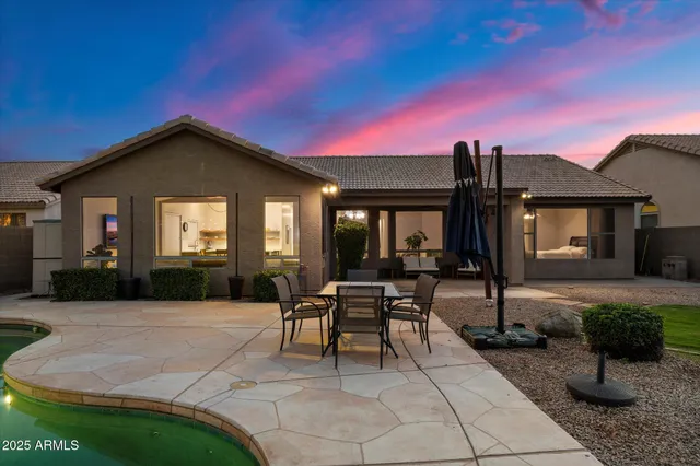 a view of a house with backyard sitting area and porch