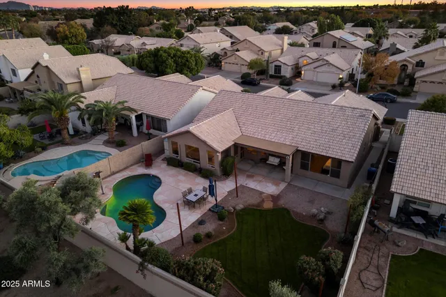 an aerial view of a house with a yard