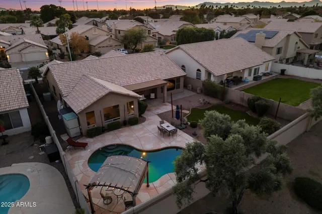 an aerial view of a house with garden space and street view