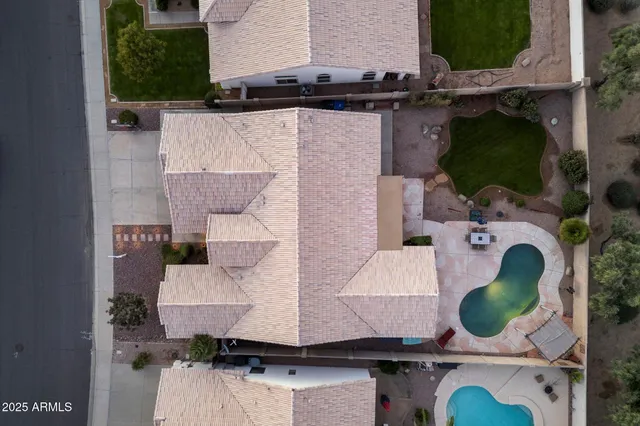 an aerial view of a house with yard and patio