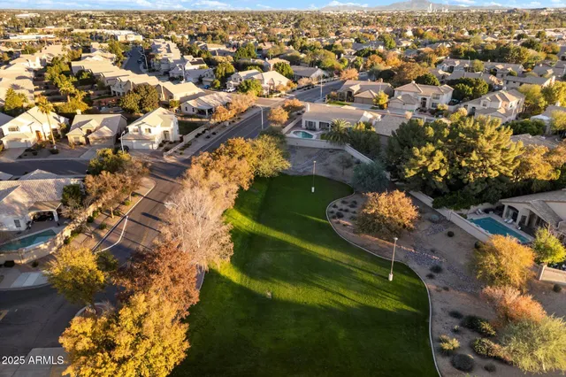 an aerial view of residential houses with outdoor space