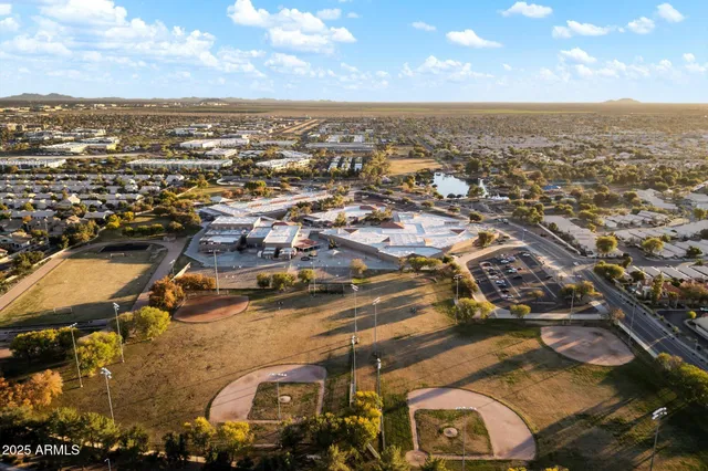an aerial view of residential houses with city view