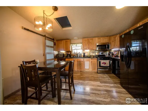 a kitchen with sink refrigerator and large window