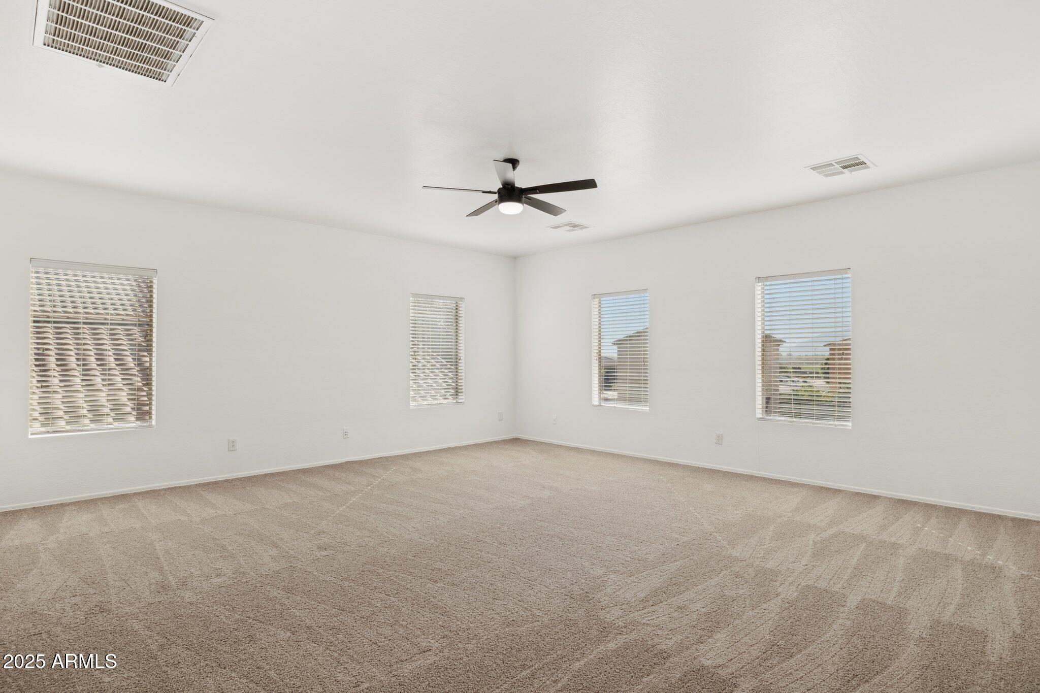 9951 West Bloch Road Tolleson, AZ 85353 - Photo 10 of 33 an empty room with windows and fan