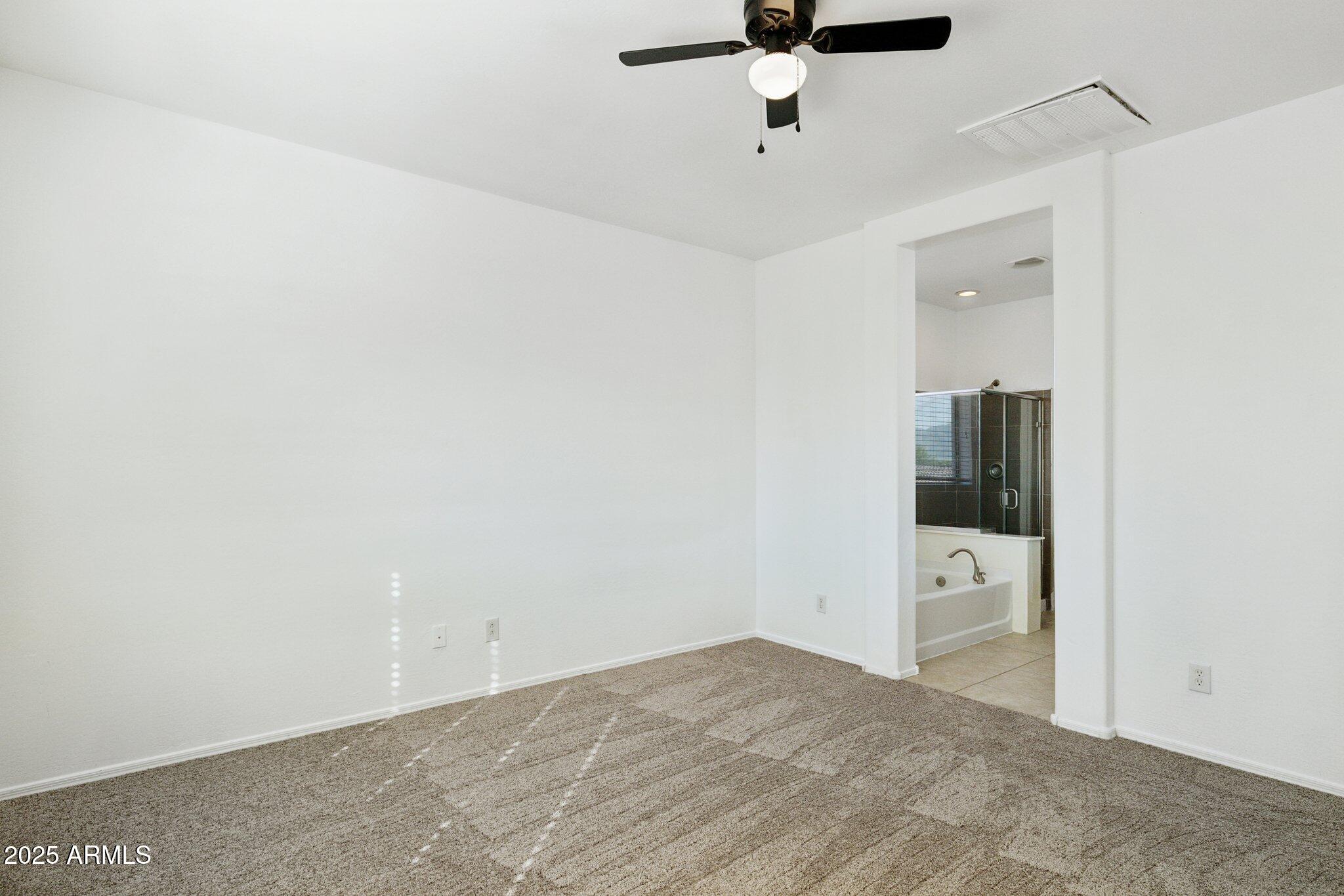 9951 West Bloch Road Tolleson, AZ 85353 - Photo 12 of 33 an empty room with fan and mirror