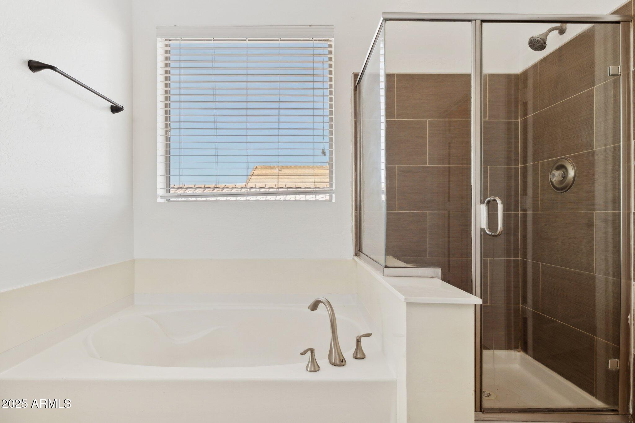 9951 West Bloch Road Tolleson, AZ 85353 - Photo 14 of 33 a bathroom with a bathtub and shower