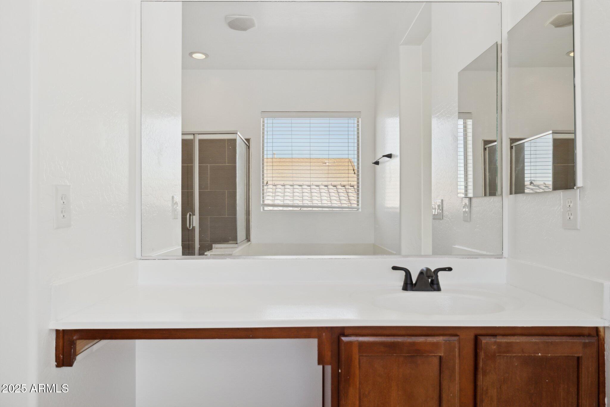 9951 West Bloch Road Tolleson, AZ 85353 - Photo 15 of 33 a bathroom with a sink and a mirror