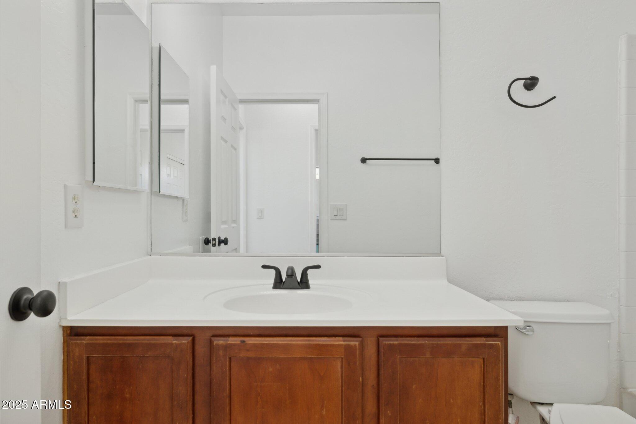 9951 West Bloch Road Tolleson, AZ 85353 - Photo 17 of 33 a bathroom with a sink and a mirror