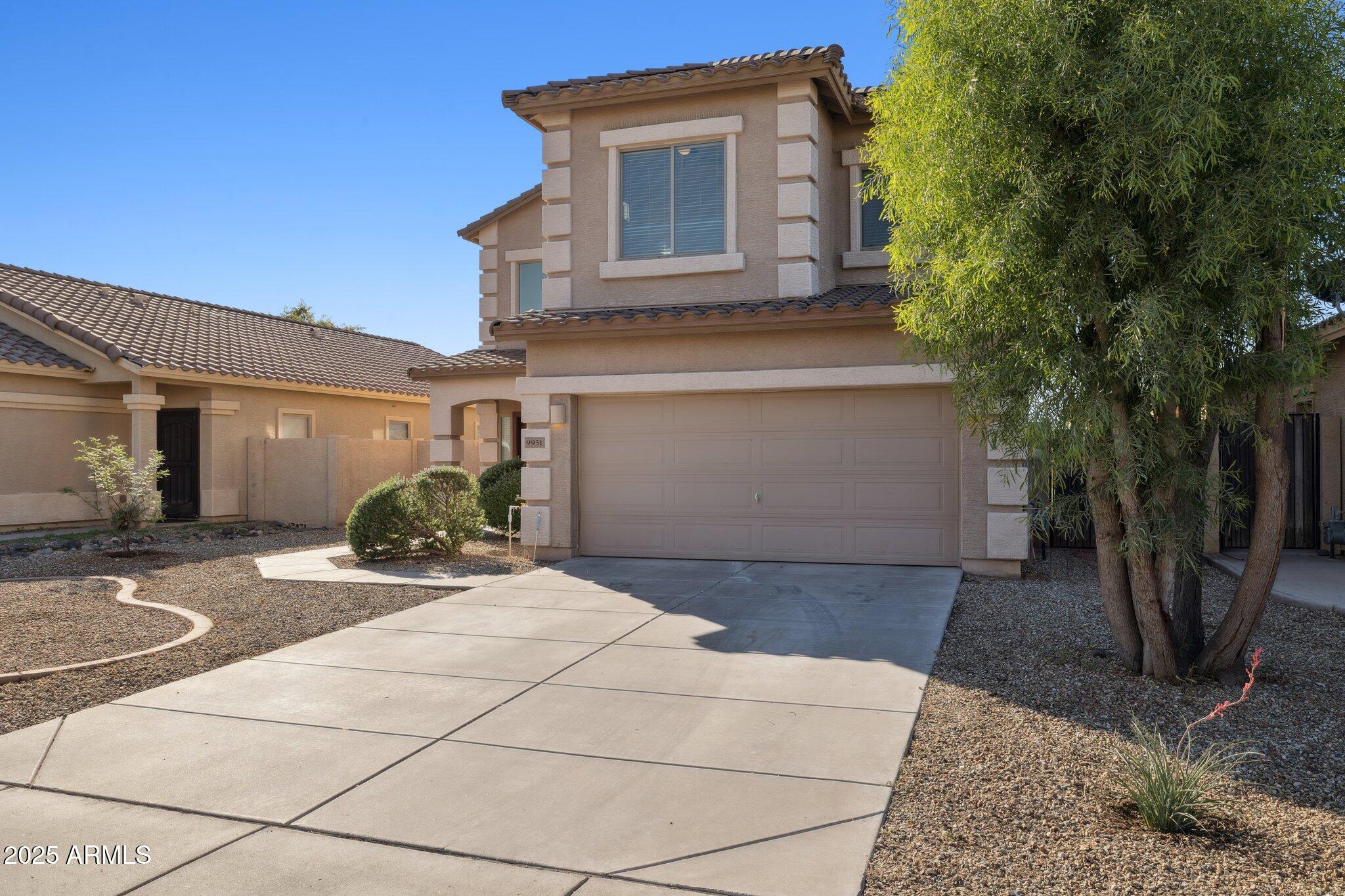 9951 West Bloch Road Tolleson, AZ 85353 - Photo 24 of 33 a front view of a house with garden