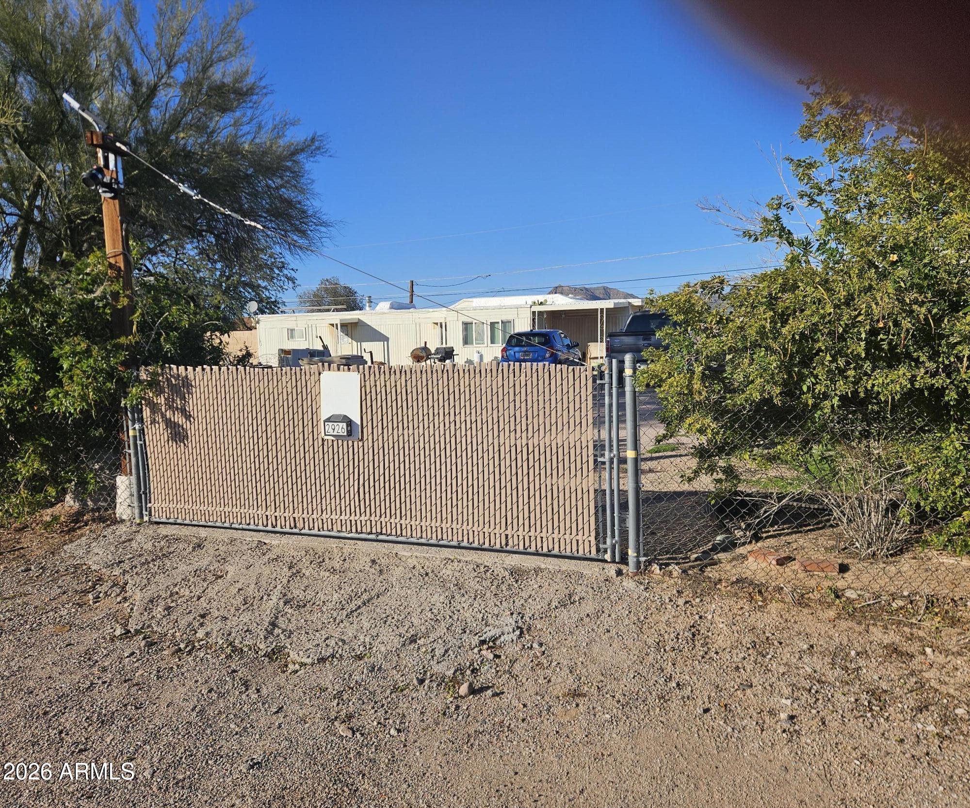 2926 West Roundup Street Apache Junction, AZ 85120 - Photo 1 of 2 a view of a barn with wooden fence