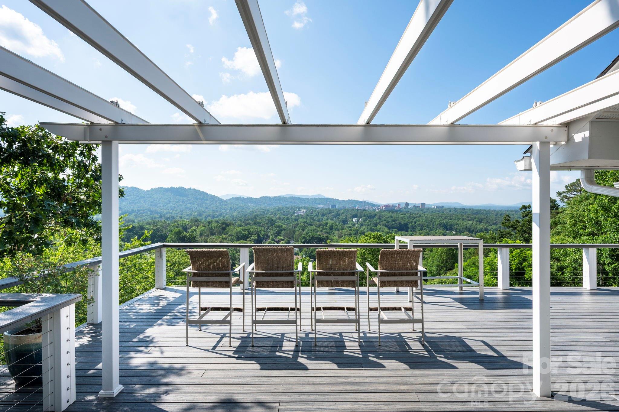 38 Lookout Road Asheville, NC 28804 - Photo 2 of 34 a view of a chairs and table in patio with a lake view