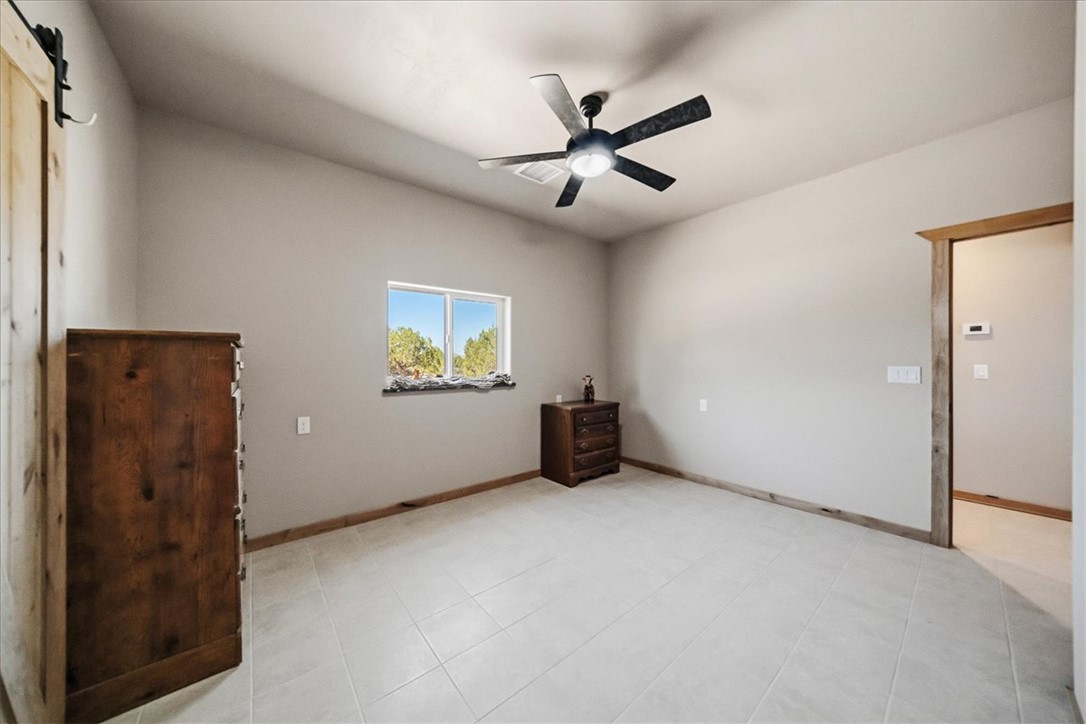 10374 East Happy Trails Road Kingman, AZ 86401 - Photo 35 of 68 an empty room with windows and fan