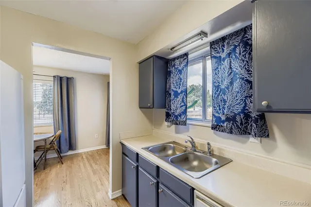 a kitchen with furniture a refrigerator and a stove