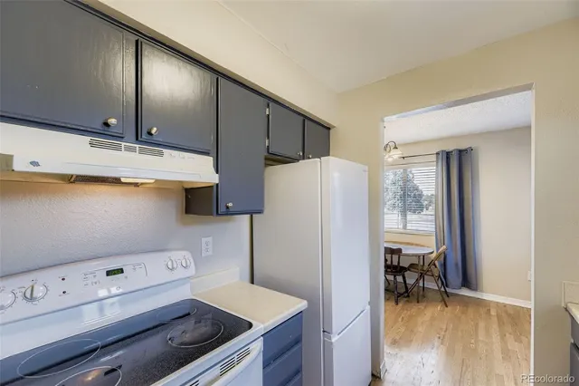 a view of a dining room with furniture and a window