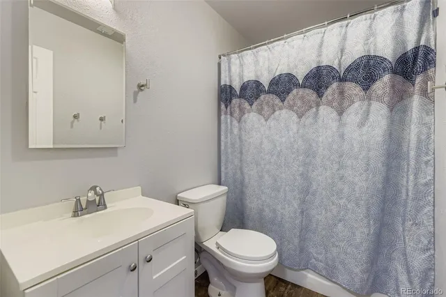a bathroom with a sink toilet and a mirror