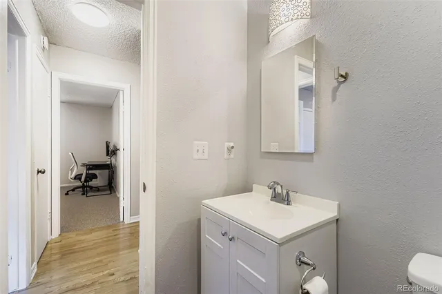 a bathroom with a sink toilet vanity and shower