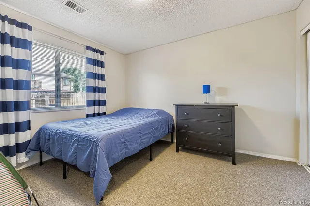 a bedroom with a bed and a bookshelf