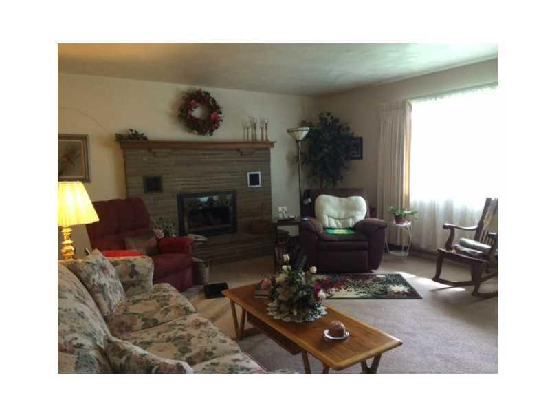 351 Elliotsville Road Farmington, PA 15437 - Photo 2 of 7 Living Room. Large sunlite living room with a gas fireplace surrounded by a stone mantle.