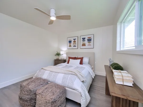 a bedroom with a bed and a window