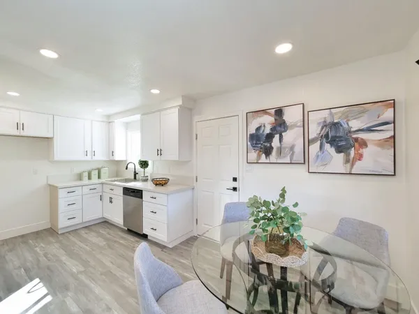 a kitchen with white cabinets and stove
