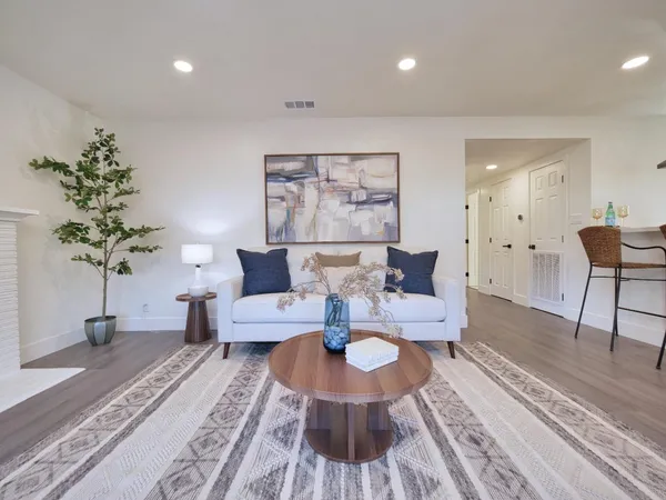 a living room with furniture and a potted plant