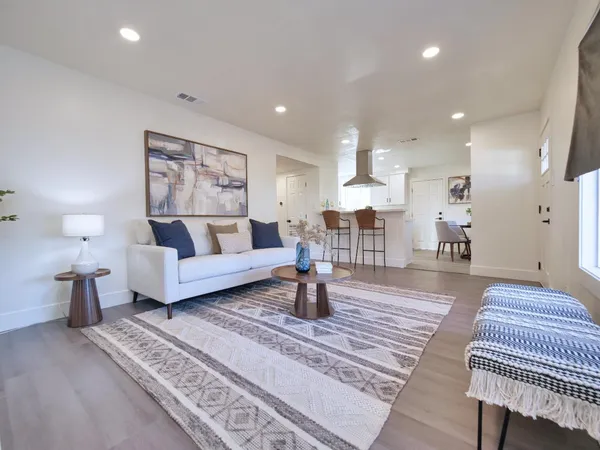 a living room with furniture and a lamp