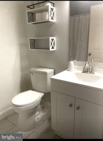 a bathroom with a sink a toilet and mirror