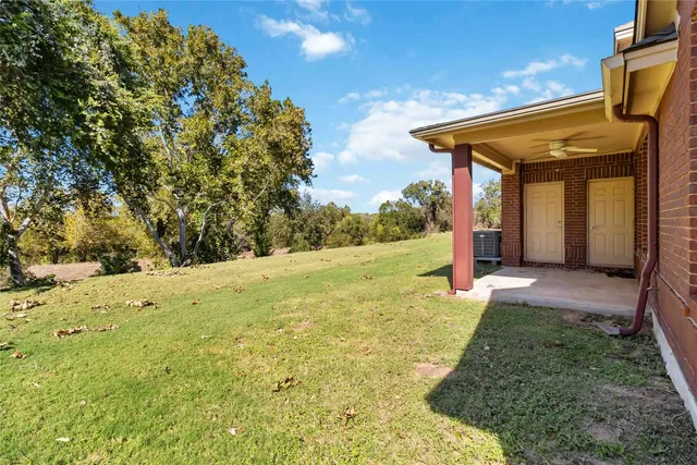 a view of a backyard with large trees