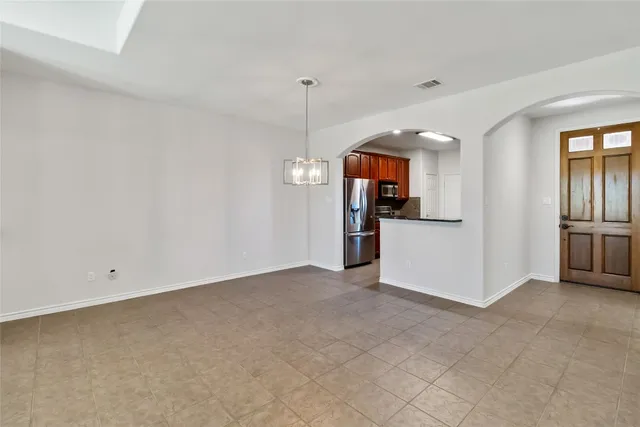 a view of a kitchen with a sink and refrigerator