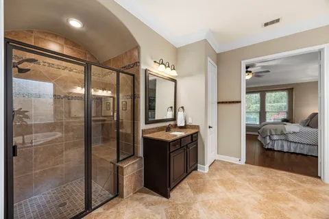 a view of a bathroom with tub shower and mirror