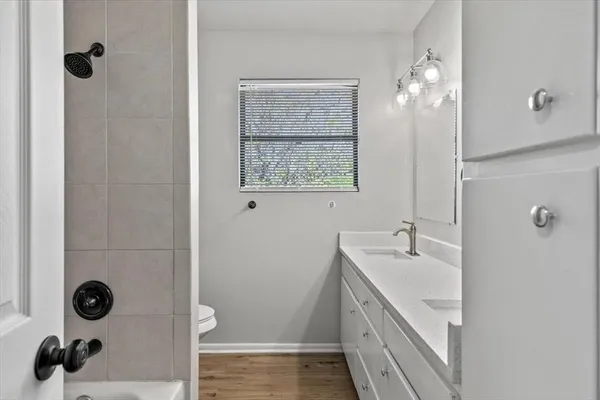 a bathroom with a sink a toilet a shower and a mirror