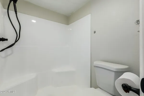 a bathroom with a toilet and a mirror
