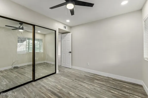 a view of empty room with wooden floor